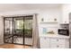 Bright kitchen with a view to a private patio featuring outdoor seating; an ideal spot for relaxing or dining at 4950 N Miller Rd # 200, Scottsdale, AZ 85251