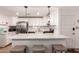 Modern kitchen with breakfast bar, stainless steel appliances, and white cabinetry for a sleek design at 4950 N Miller Rd # 200, Scottsdale, AZ 85251
