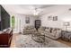 Comfortable living room with neutral tones, two sofas, a glass coffee table, and plenty of natural light at 4950 N Miller Rd # 200, Scottsdale, AZ 85251