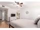 Bright main bedroom features wood floors, ceiling fan, ensuite bath, and white dresser at 4950 N Miller Rd # 200, Scottsdale, AZ 85251