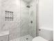 Updated shower features decorative accent and large format white marble tiling at 4950 N Miller Rd # 200, Scottsdale, AZ 85251