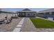 Landscaped backyard with a patio, artificial turf, and easy access to the home at 5048 N 84Th Dr, Glendale, AZ 85305