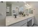 Bathroom featuring double vanity with white countertop and backsplash at 5048 N 84Th Dr, Glendale, AZ 85305