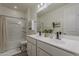 This bathroom features a double sink vanity, a shower-tub combo, and neutral decor at 5048 N 84Th Dr, Glendale, AZ 85305