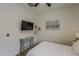 This cozy bedroom features a ceiling fan, a TV on the wall, and modern decor at 5048 N 84Th Dr, Glendale, AZ 85305