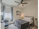 This comfortable bedroom features a ceiling fan, a TV, modern decor, and light-filled windows at 5048 N 84Th Dr, Glendale, AZ 85305