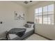 Cozy bedroom with natural light, a twin bed, and a fluffy rug, creating a serene and comfortable space at 5048 N 84Th Dr, Glendale, AZ 85305