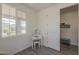 Bright bedroom with a vanity, window, and an adjacent doorway, creating an inviting and versatile space at 5048 N 84Th Dr, Glendale, AZ 85305