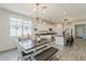 Open concept dining area with an ornamental light fixture and adjacent kitchen at 5048 N 84Th Dr, Glendale, AZ 85305