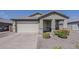Charming single-story home featuring a neutral color palette, manicured landscaping, and a two-car garage at 5048 N 84Th Dr, Glendale, AZ 85305