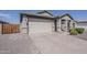 Single-story home with a spacious driveway, a neutral color palette, and a well-maintained front yard at 5048 N 84Th Dr, Glendale, AZ 85305
