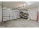 Spacious garage with shelving for storage, a garage door, and access to the house at 5048 N 84Th Dr, Glendale, AZ 85305