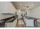 Spacious kitchen featuring white cabinets, a stainless steel refrigerator and a kitchen island at 5048 N 84Th Dr, Glendale, AZ 85305