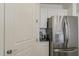 This kitchen features stainless steel refrigerator and white cabinetry at 5048 N 84Th Dr, Glendale, AZ 85305