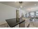 Open-concept kitchen island with bar seating, stainless steel appliances and modern pendant lighting at 5048 N 84Th Dr, Glendale, AZ 85305