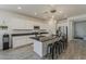 Modern kitchen featuring white cabinetry, sleek countertops, a large island with seating, and stainless steel appliances at 5048 N 84Th Dr, Glendale, AZ 85305