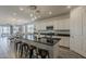Modern open-concept kitchen with sleek countertops, stainless steel appliances, and a stylish island with seating at 5048 N 84Th Dr, Glendale, AZ 85305