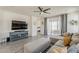 Spacious living room with a large sectional sofa, ceiling fan, and access to outdoor patio at 5048 N 84Th Dr, Glendale, AZ 85305