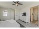 Spacious main bedroom with a dresser, a ceiling fan, and an ensuite bathroom at 5048 N 84Th Dr, Glendale, AZ 85305