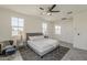 Well-lit main bedroom featuring large windows, ceiling fan, and stylish furnishings at 5048 N 84Th Dr, Glendale, AZ 85305
