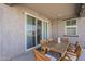 Covered outdoor patio with a wooden dining table and comfortable seating at 5048 N 84Th Dr, Glendale, AZ 85305