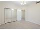 Neutral-colored carpeted bedroom with a sliding mirrored closet door at 530 N Jesse Ct, Chandler, AZ 85225