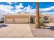 Charming beige home with a three-car garage, tile roof, and well-maintained landscaping at 530 N Jesse Ct, Chandler, AZ 85225