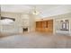 Open living space showcasing a fireplace, built-in shelving, and access to the front entry at 530 N Jesse Ct, Chandler, AZ 85225