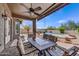 Inviting covered patio with dining set overlooking a pool and desert landscape, perfect for outdoor living at 5537 E Dusty Wren Dr, Cave Creek, AZ 85331