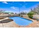Backyard features a refreshing pool surrounded by mature desert plants and a sunny sky at 5537 E Dusty Wren Dr, Cave Creek, AZ 85331
