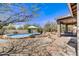 Backyard with a private pool, desert landscaping, and brick patio, ideal for relaxation and entertainment at 5537 E Dusty Wren Dr, Cave Creek, AZ 85331