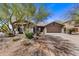Charming single-story home with a well-maintained front yard and desert landscaping under a clear blue sky at 5537 E Dusty Wren Dr, Cave Creek, AZ 85331