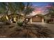 Charming single-story home featuring desert landscaping, a two-car garage, and a welcoming facade under a vibrant sky at 5537 E Dusty Wren Dr, Cave Creek, AZ 85331