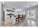 Modern kitchen with white cabinetry, granite countertops, an island with seating, and stainless appliances at 5537 E Dusty Wren Dr, Cave Creek, AZ 85331