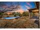 Backyard featuring a pool with desert landscaping and an outdoor patio with dining table and chairs at 5537 E Dusty Wren Dr, Cave Creek, AZ 85331