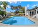 Spacious backyard with a refreshing pool, lounge chairs, and mature trees at 6271 E Evans Dr, Scottsdale, AZ 85254