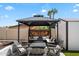 Charming gazebo lounge area with comfortable seating and a cozy outdoor fireplace at 6271 E Evans Dr, Scottsdale, AZ 85254