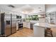 Bright, modern kitchen with white cabinets, stainless steel appliances, and a stylish breakfast bar at 6271 E Evans Dr, Scottsdale, AZ 85254