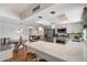 Open-concept kitchen featuring white marble countertops, stainless steel appliances, and bar seating at 6271 E Evans Dr, Scottsdale, AZ 85254