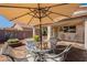 Backyard featuring patio area with umbrella-covered table and chairs at 6397 S Pinaleno Pl, Chandler, AZ 85249