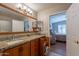 Bathroom boasts wood cabinets, granite counters, and access to the bedroom at 6397 S Pinaleno Pl, Chandler, AZ 85249