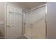 Bathroom showcasing walk-in shower with glass doors and door to outside at 6397 S Pinaleno Pl, Chandler, AZ 85249