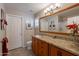 Bathroom features granite counters, wood cabinets, and ample lighting at 6397 S Pinaleno Pl, Chandler, AZ 85249