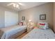 Charming bedroom with twin beds, soft lighting, and tasteful decor creating a cozy and inviting space at 6397 S Pinaleno Pl, Chandler, AZ 85249