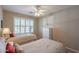 Comfortable bedroom with twin beds, neutral walls, and a ceiling fan offering a bright and airy feel at 6397 S Pinaleno Pl, Chandler, AZ 85249