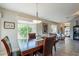 Elegant dining area with a wooden table and large windows providing natural light at 6397 S Pinaleno Pl, Chandler, AZ 85249