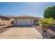 Inviting home showcasing a manicured lawn, desert foliage, tile roof and a convenient two-car garage at 6397 S Pinaleno Pl, Chandler, AZ 85249
