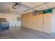 Spacious garage featuring epoxy flooring and built-in cabinets, providing ample storage solutions at 6397 S Pinaleno Pl, Chandler, AZ 85249