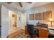 Well-lit home office featuring an adjacent bathroom, desk and chair, with natural light streaming in at 6397 S Pinaleno Pl, Chandler, AZ 85249