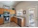 Bright kitchen with stainless steel appliances, wooden cabinets, and a view to the backyard at 6397 S Pinaleno Pl, Chandler, AZ 85249